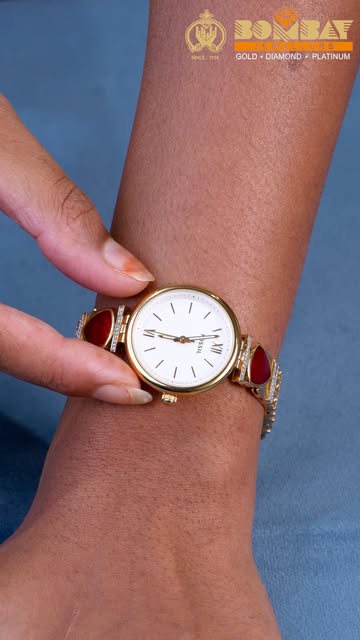 Gold-tone bracelet watch with red gemstone details